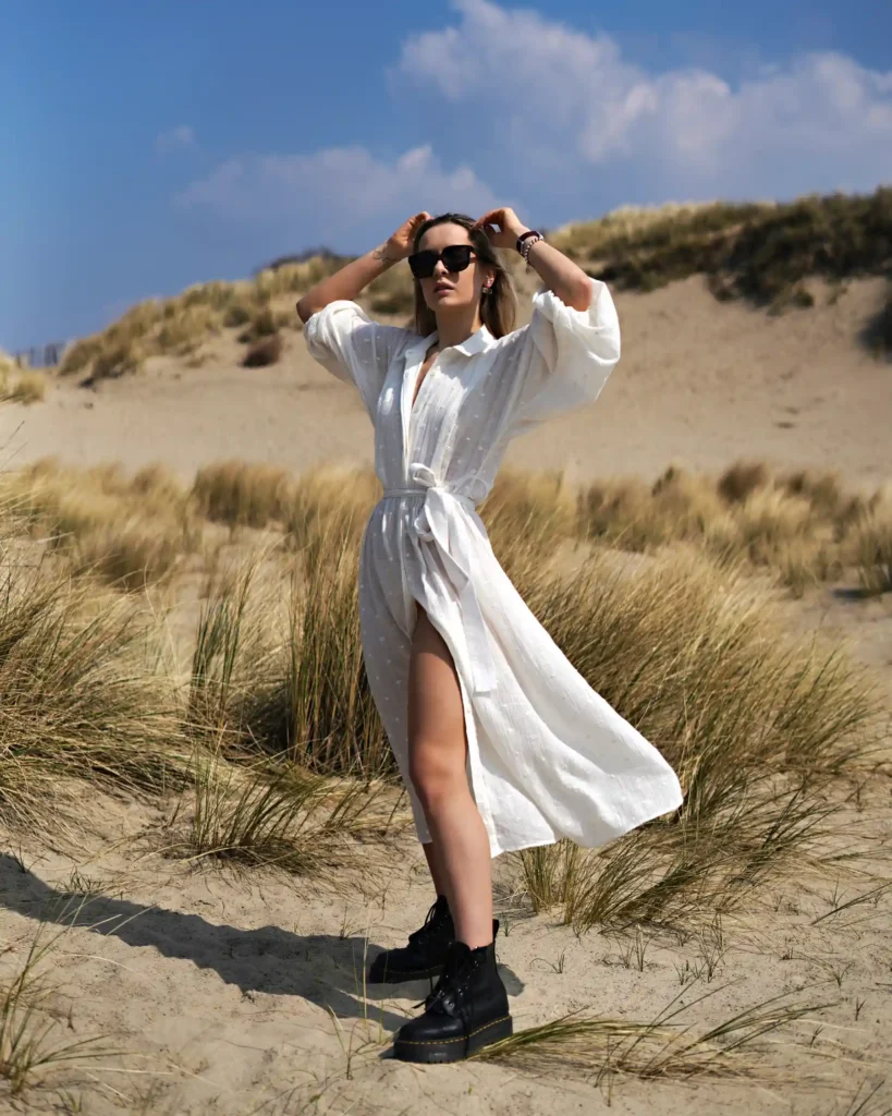 artistic portrait photography of a woman in a white dress on the beach made with retro photography lens