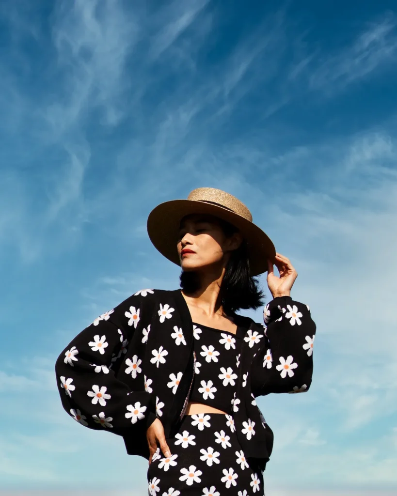 artistic portrait photography of a woman in a gucci dress and a hat in the park made with retro photography lens