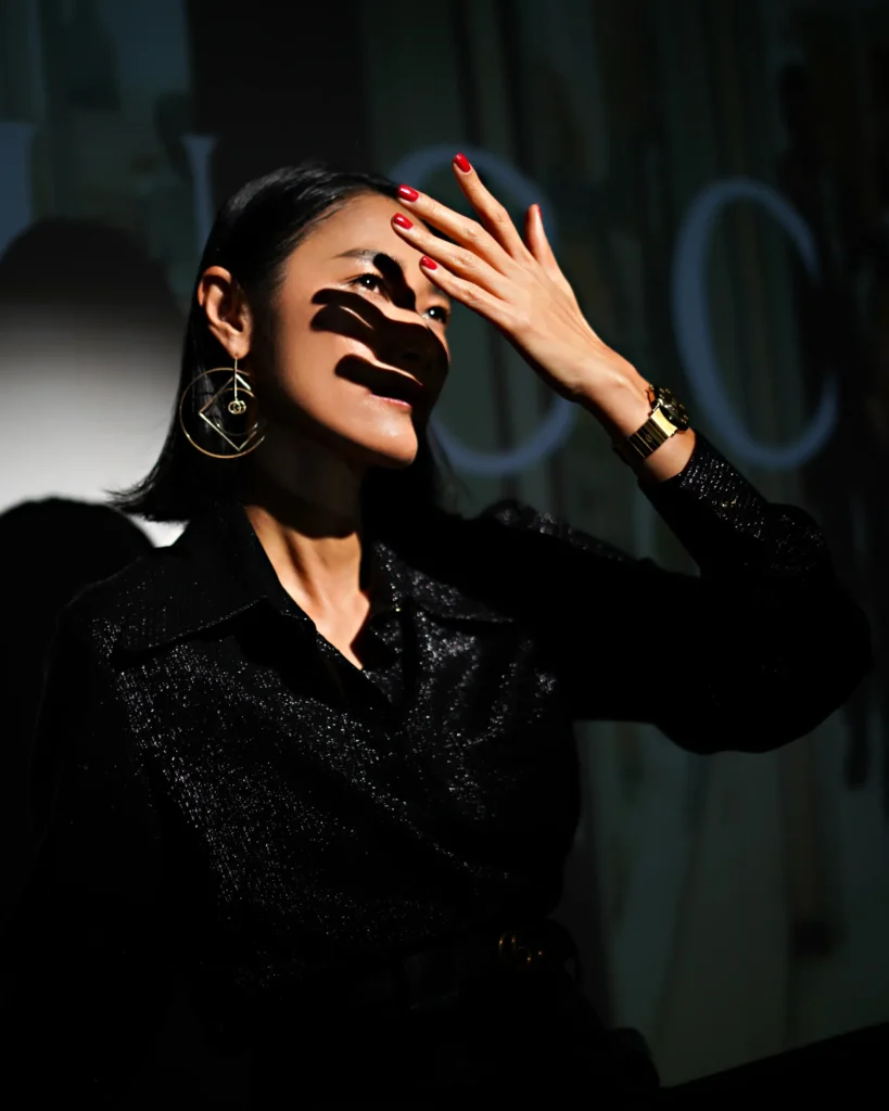 artistic portrait photography of a woman in a gucci dress with dynamic light in black colours