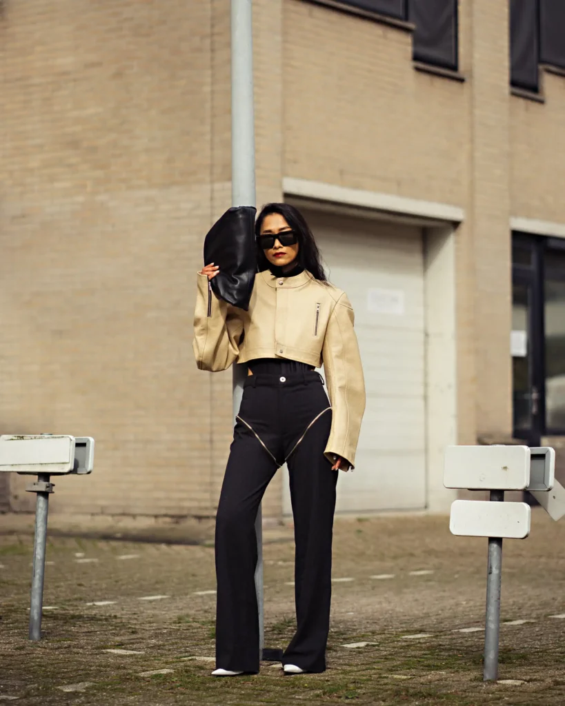 artistic portrait photography of a woman in a beige pastel colours with fashion bag