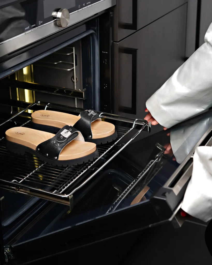 creative inside studio photography of a scholl shoes. close up of a shoes in the kitchen in the oven