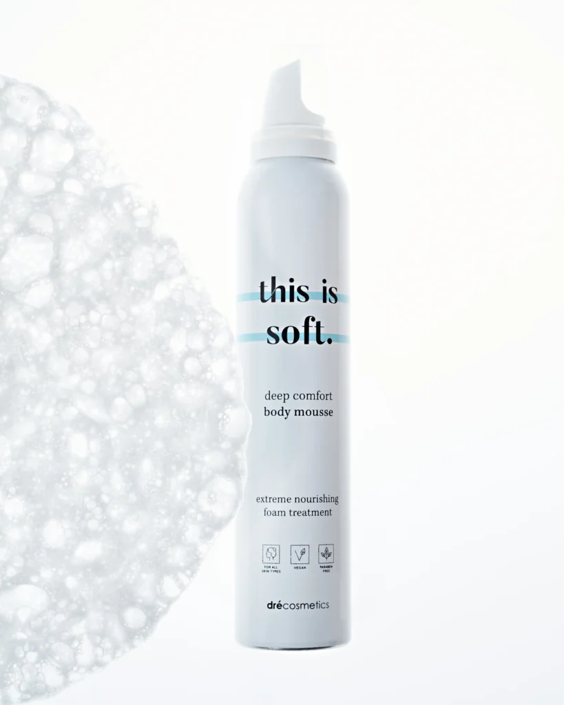 creative product advertising photo with a bottle of a body foam cream, white background