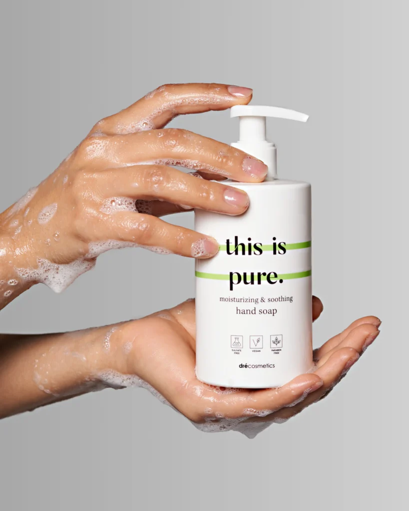 creative product advertising photo with a wet soapy hands holding a shower gel