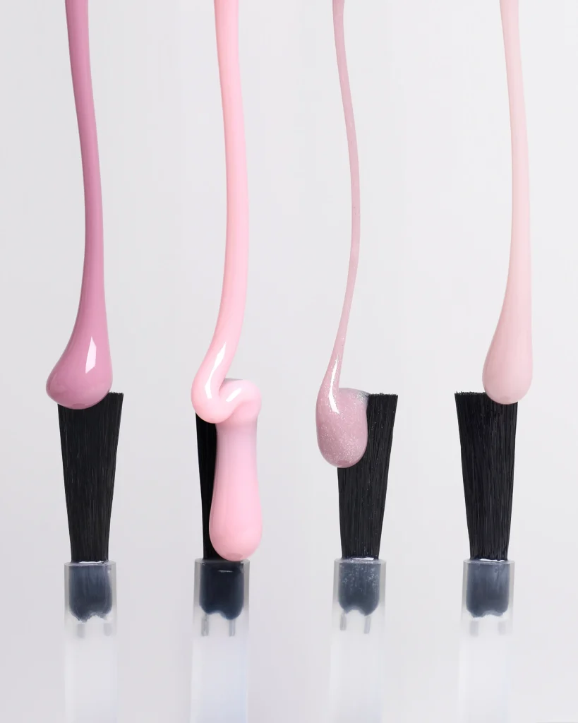 creative still life close up photography of nail polish gel drops on the grey background