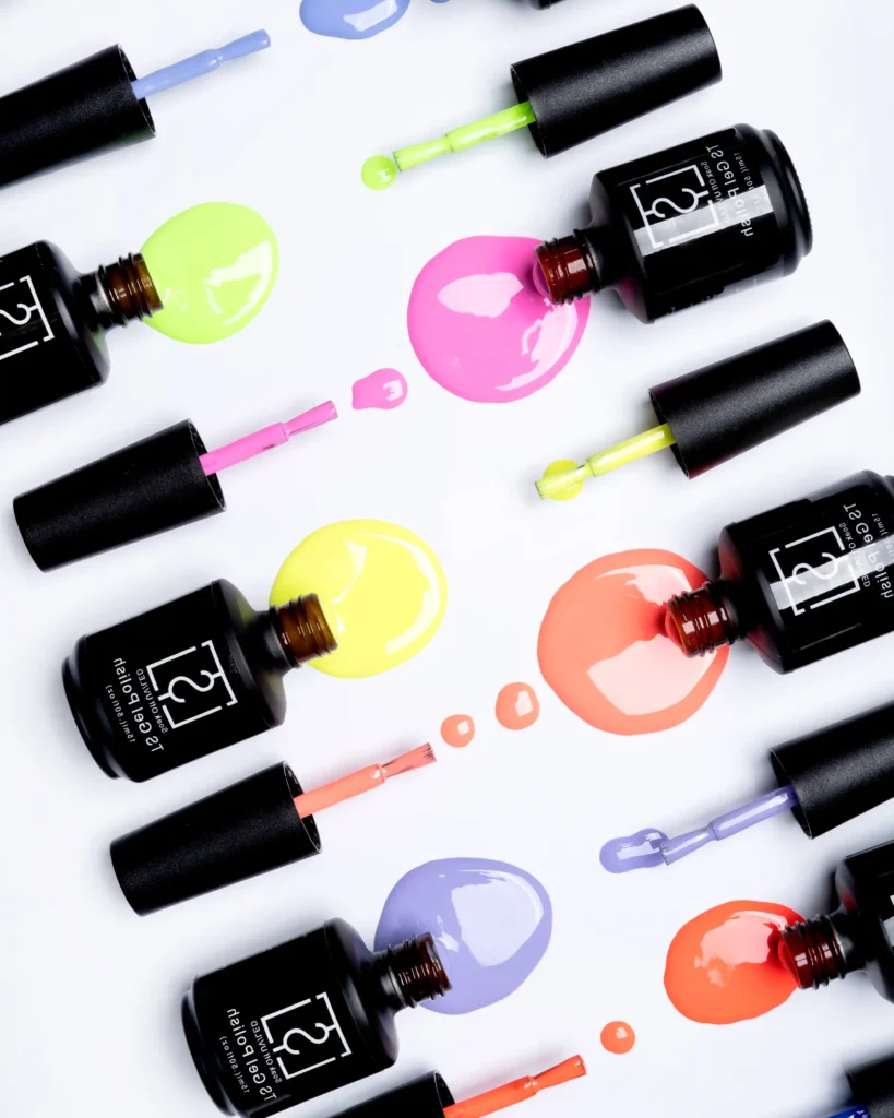 creative still life close up photography of nail polish gel drops on the white colourful background