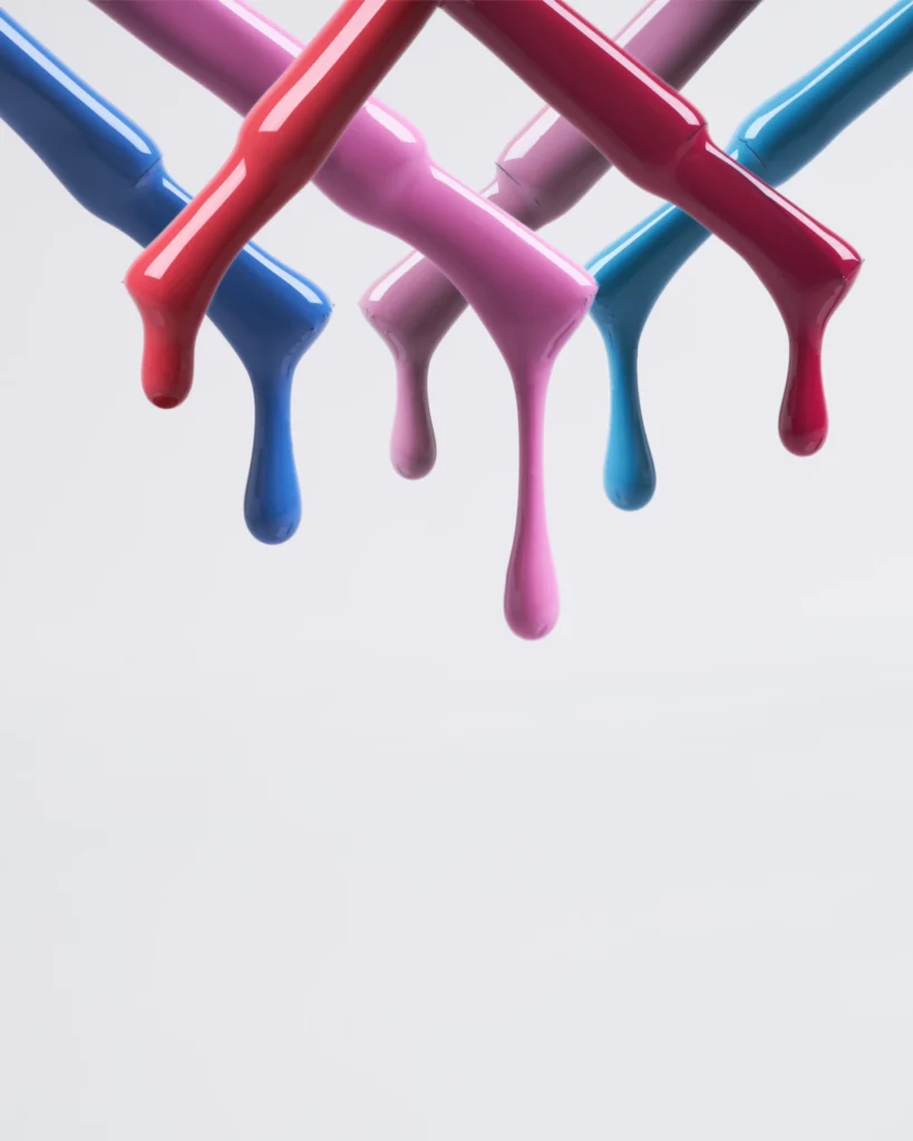 creative still life close up photography of nail polish gel drops on the grey background