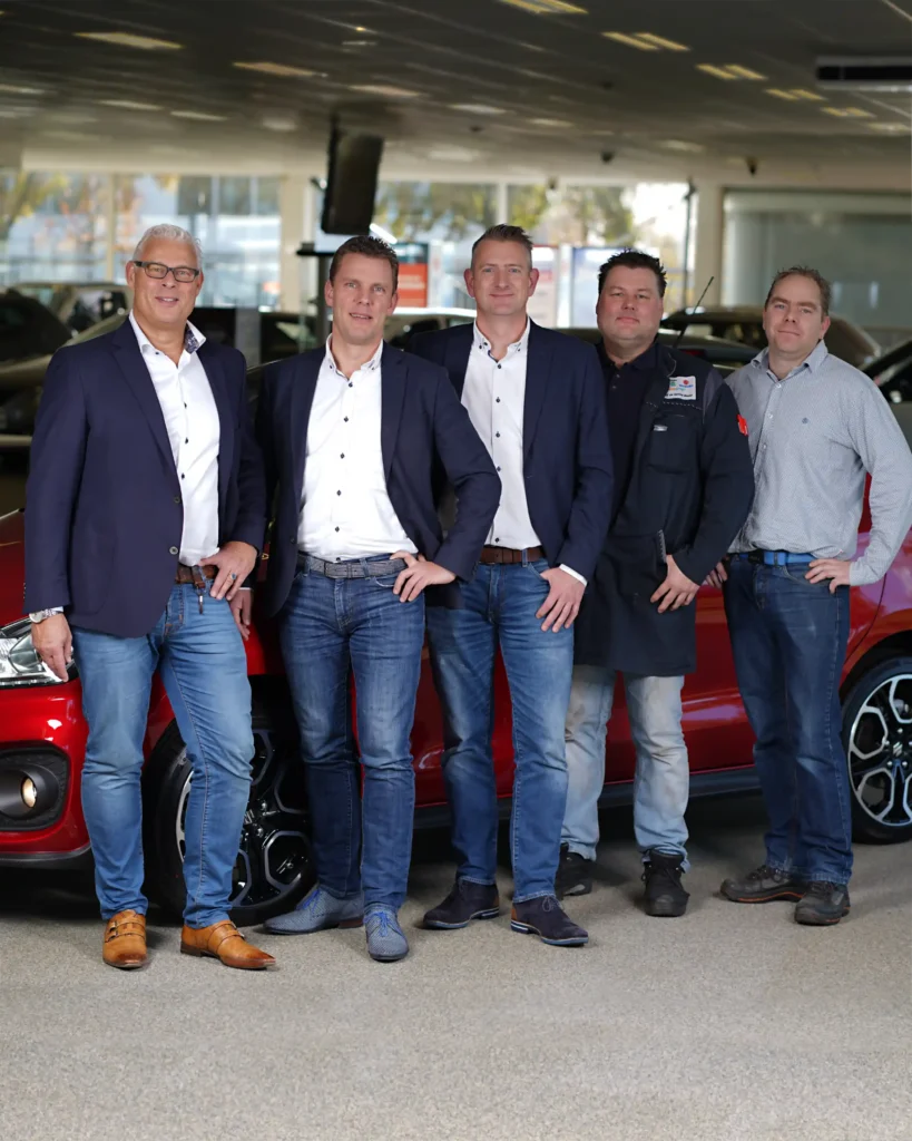 personal branding company photography of a car salesman team in the office next to a car