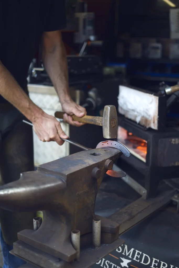 personal branding photography of a man making a new shoe for a horse