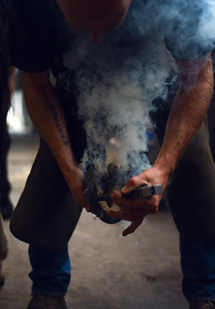 personal branding photography of a man changing the horse shoe