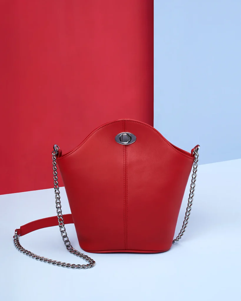 still life Packshot product photography of a red bag on a blue background