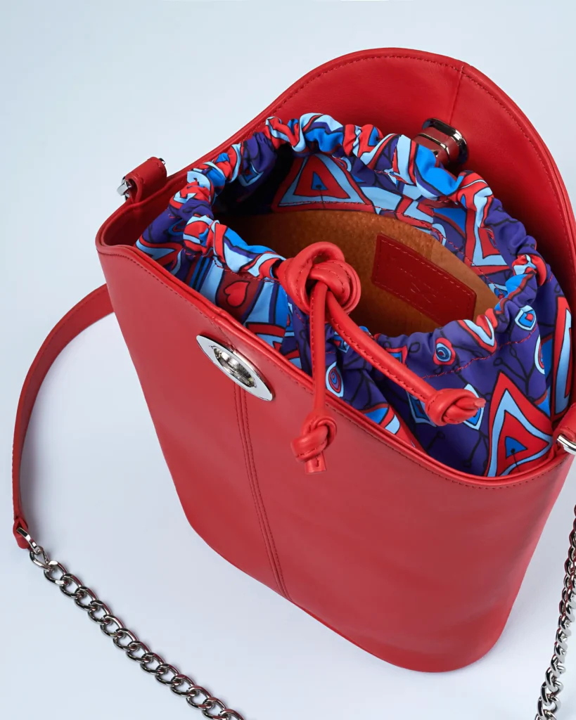 still life Packshot product photography of a red bag on a blue background with the shot of the inside