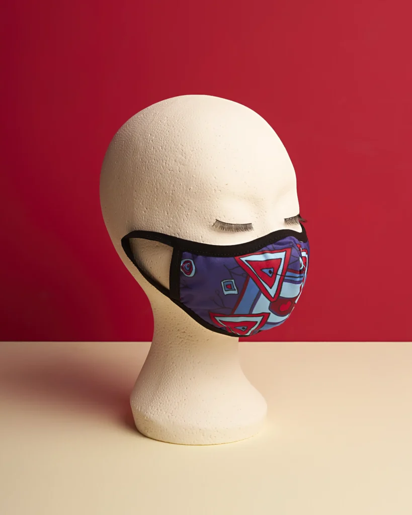 still life Packshot product photography of mouth mask on a red and beige background on a mannequin head